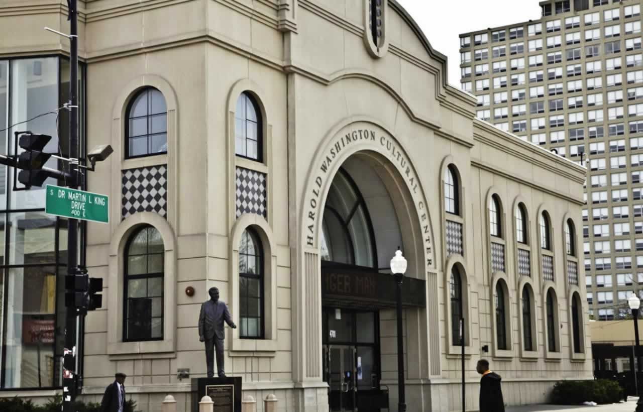 The limestone facade of the Harold Washington Cultural Center at 47th and King Drive, with the Harold Washington statue at the entrance
